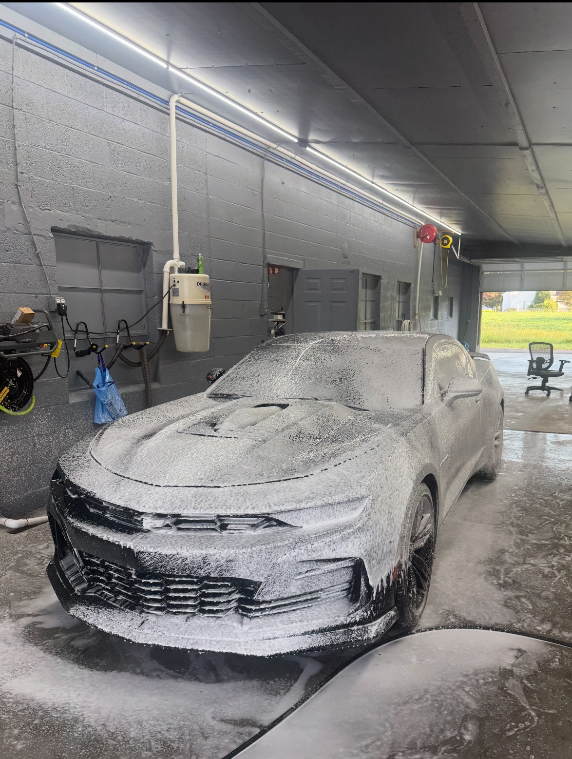 Camaro covered in snow foam during the pre-wash stage