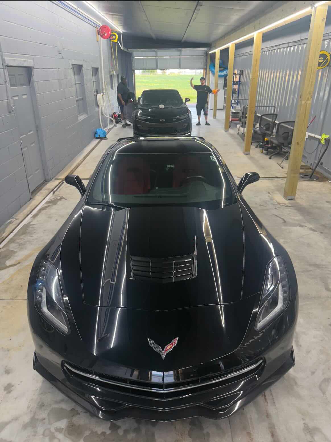 Corvette in the Frankford Auto Center bay with the team working