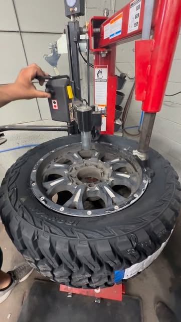 A tire being mounted on the machine